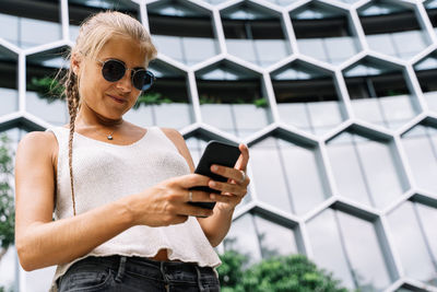 Midsection of woman using mobile phone