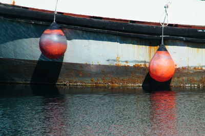 Close-up of lantern hanging over water