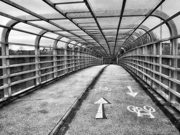 High angle view of arrow symbol on bridge walkway