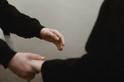 Midsection of couple holding hands