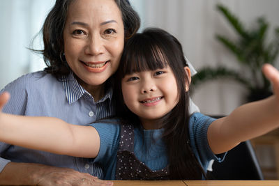 Portrait of smiling grandmother with granddaughter