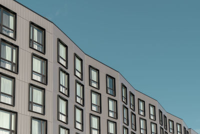 Low angle view of building against clear blue sky