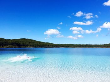 Scenic view of lake against blue sky