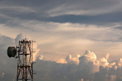 Low angle view of communications tower against sky during sunset