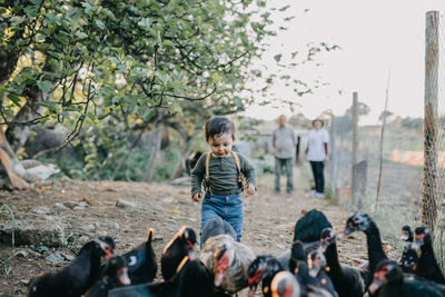 Rear view of children on land