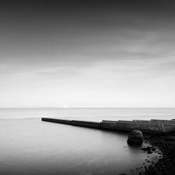 Pier amidst sea against sky during foggy weather