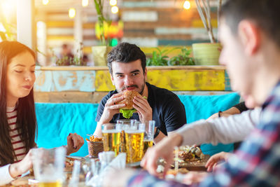 Portrait of people eating food at restaurant