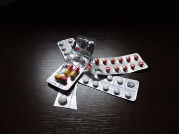 Pills in packets on wooden table