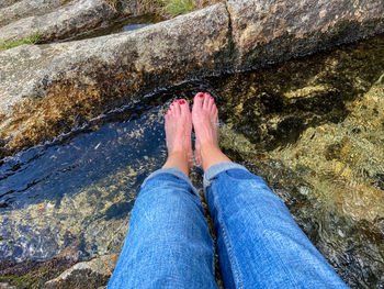 Low section of woman legs on rock