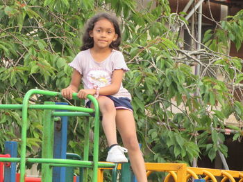 Portrait of a smiling girl sitting outdoors