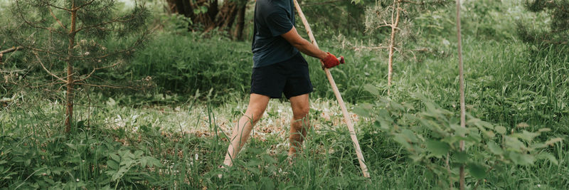 Rear view of woman standing on field