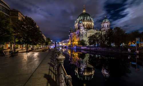 Panoramic view of illuminated buildings against sky at night