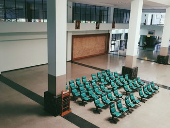 Empty chairs and tables in building