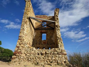 Low angle view of old ruins against sky