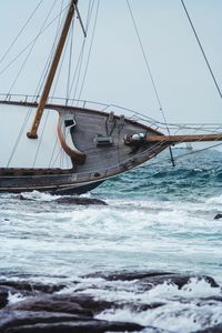 Sailboat sailing on sea against sky