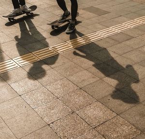 Low section of man standing on tiled floor