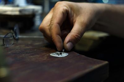 Close-up of hand holding table