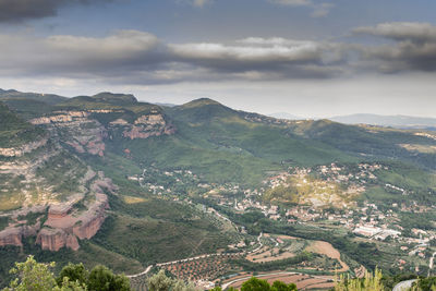 High angle view of townscape and mountains against sky