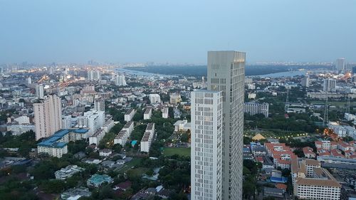 High angle view of city buildings against clear sky