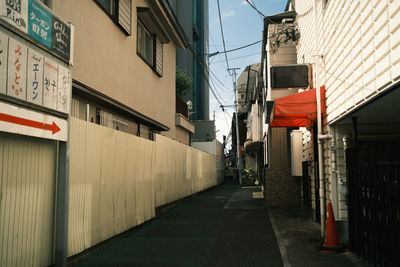 Narrow street amidst buildings in city