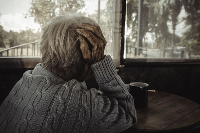 Adult woman, old person has a headache. concept loneliness, dementia, abuse, sadness, healthcare.