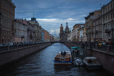 Boats in canal in city