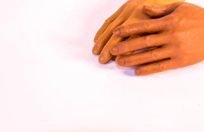 Close-up of woman hand over white background