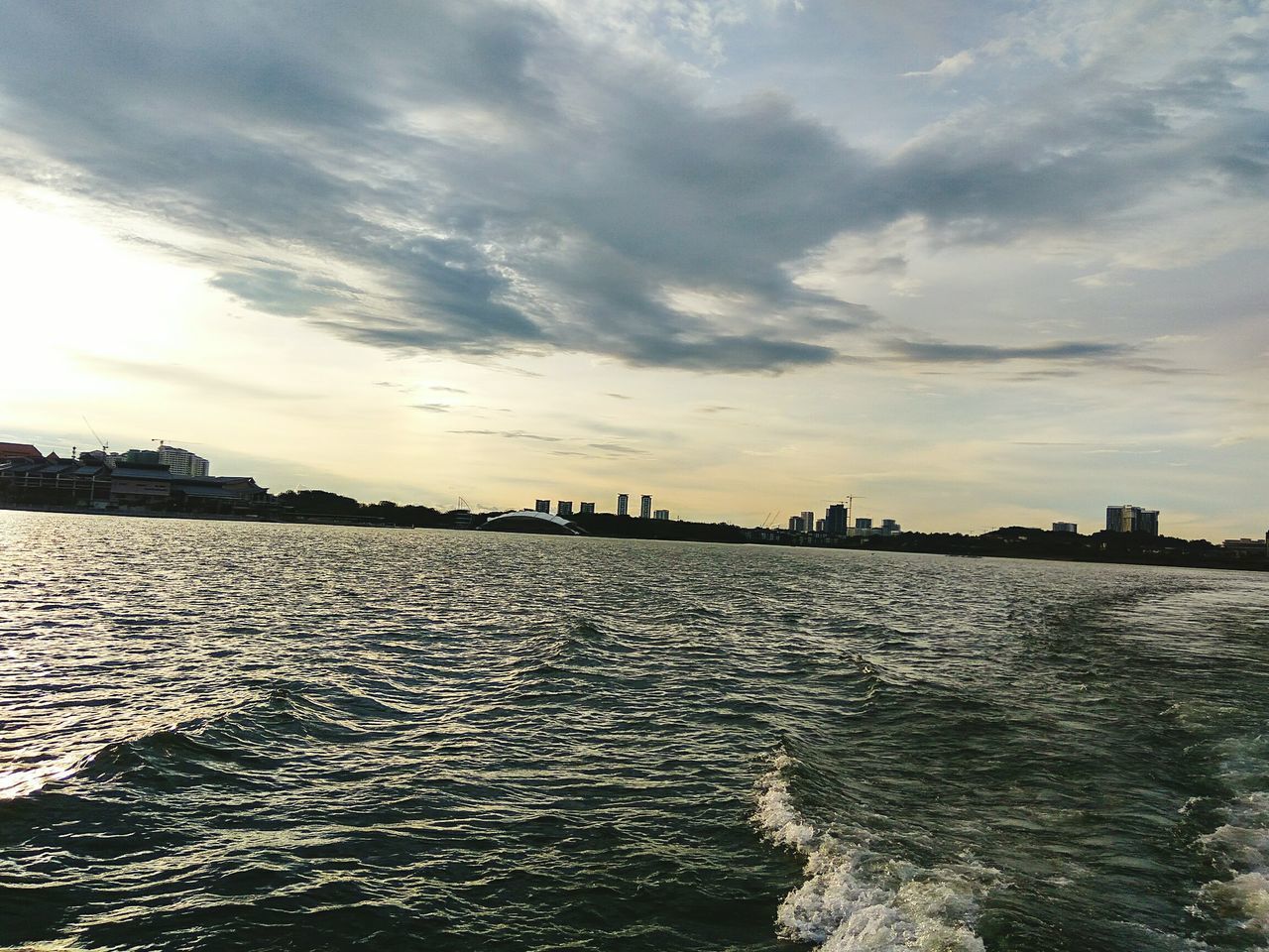 SCENIC VIEW OF SEA AGAINST BUILDINGS IN CITY