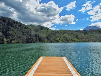 Pier over lake against sky