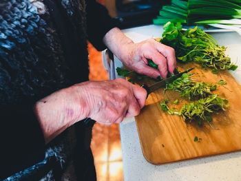 High angle view of man preparing food on cutting board