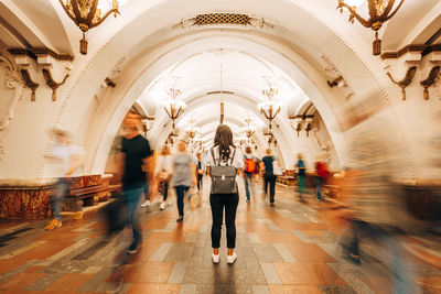 Group of people walking in corridor of building