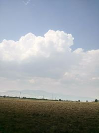 Scenic view of landscape against cloudy sky