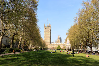 Group of people in park with buildings in background