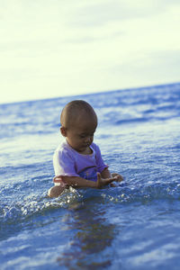 Full length of cute little girl in sea