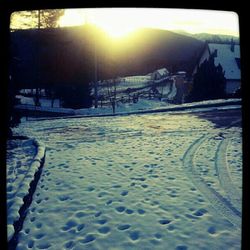 Snow covered road at sunset