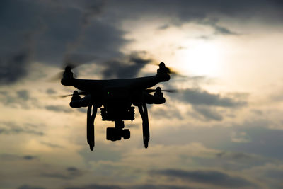 Close-up of drone against sky during sunset