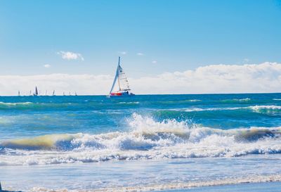 Sailboat in sea against sky