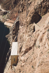 High angle view of building amidst rocky mountains at hoover dam