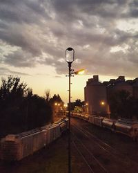 Railroad tracks against cloudy sky