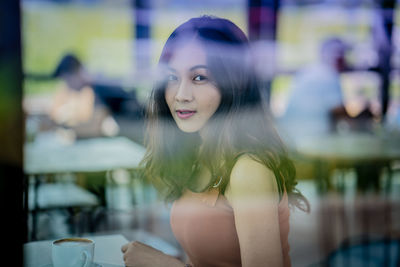 Portrait of young woman looking away