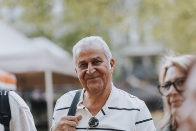 Portrait of smiling senior man with friends
