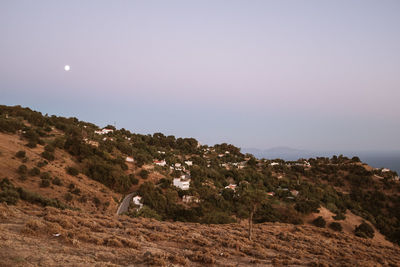 Scenic view of land against clear sky at night