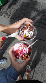 High angle view of woman holding ice cream