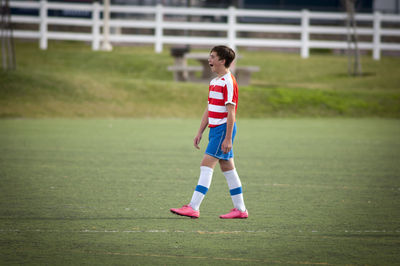 Teen soccer player yawning on the soccer field