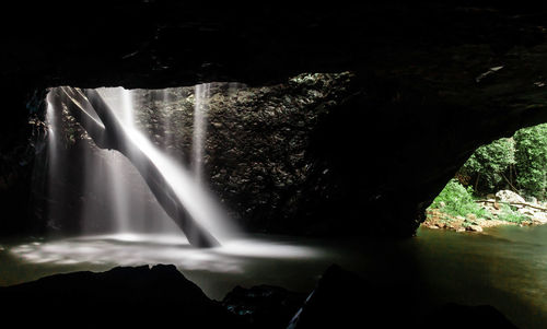 Scenic view of waterfall against sky