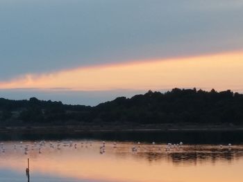 Scenic view of lake against sky during sunset