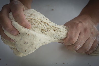 Man kneading a large dough for homemade bread in quarantine