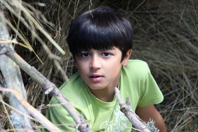 High angle portrait of boy standing at field