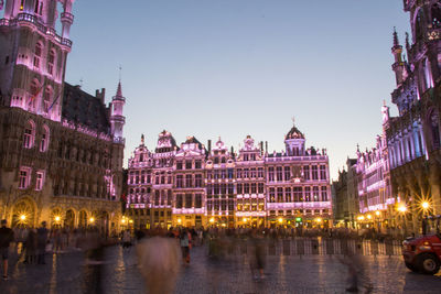 Illuminated buildings in city at dusk