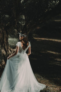 Bride standing on field at night